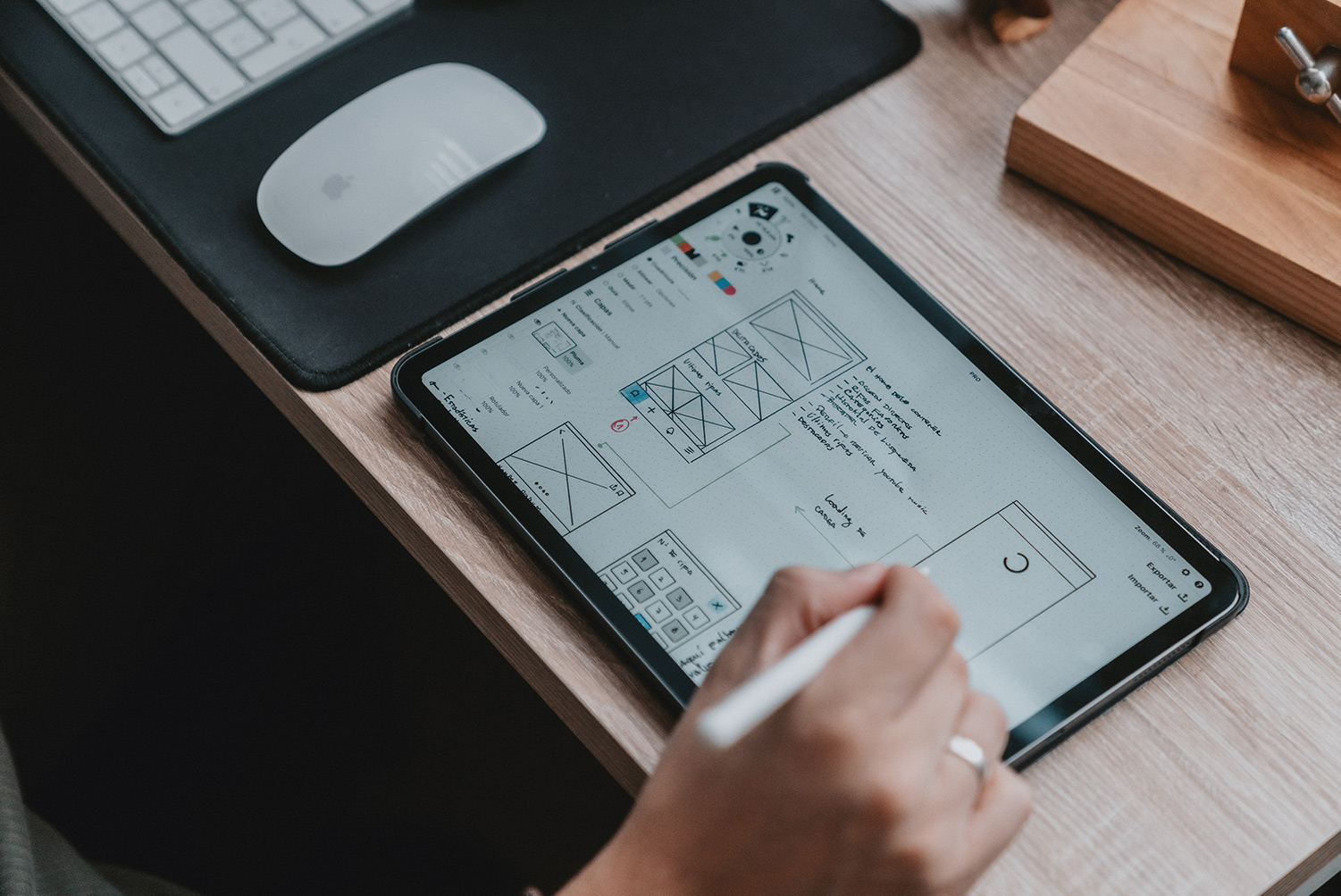 Hand scetching a wireframe on tablet